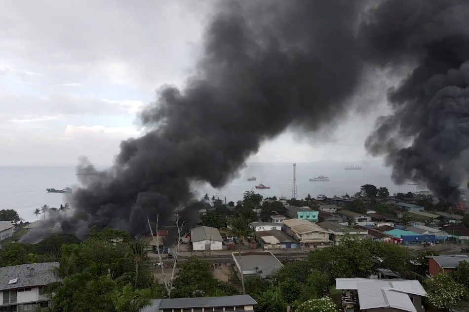 Smoke rises above buildings after days of unrest in Honiara, Solomon Islands November 25, 2021 in this still image obtained from a video recorded with a drone on November 25, 2021 and obtained November 27, 2021. Jone Tuiipelehaki/via Reuters