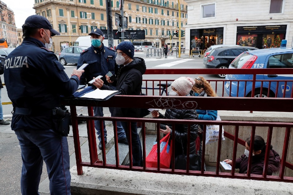 Police officers check people's coronavirus disease (COVID-19) health passes, known as a Green Pass, at a subway station the day the government restricts access of unvaccinated to indoor venues, in Rome, Italy December 6, 2021. Remo Casilli, Reuters
