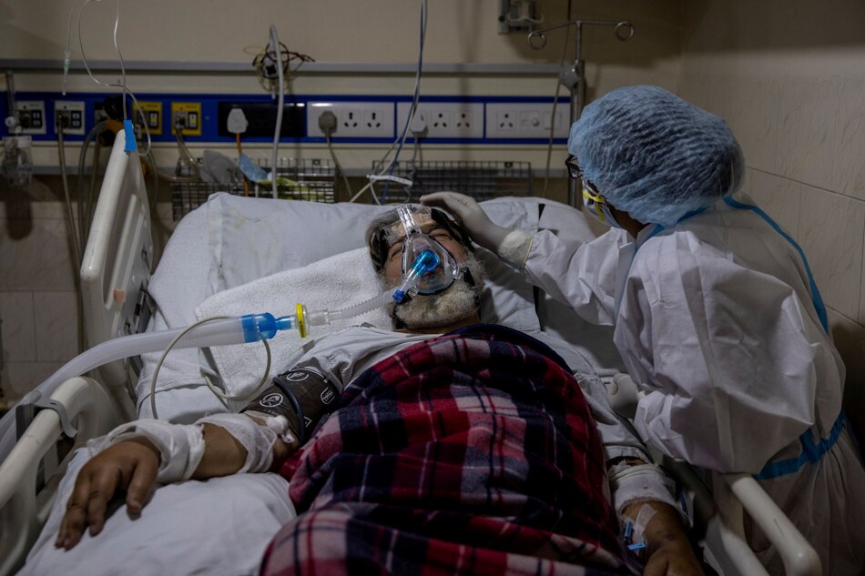 A medical worker tends to a patient suffering from the coronavirus disease (COVID-19), inside the ICU ward at Holy Family Hospital in New Delhi, India, April 29, 2021.