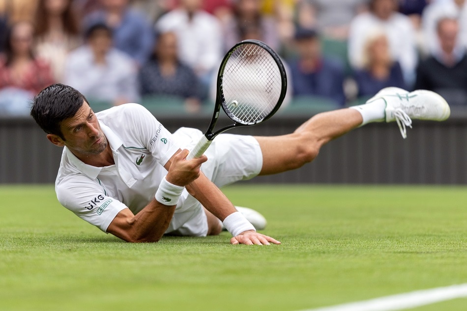 Tennis Djokovic slides to victory as Wimbledon makes soggy return