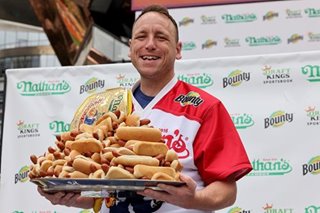 Hot-dog eating champ breaks own record by downing 76 franks and buns