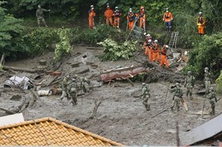 Rescuers search for survivors in landslide-hit Japan town
