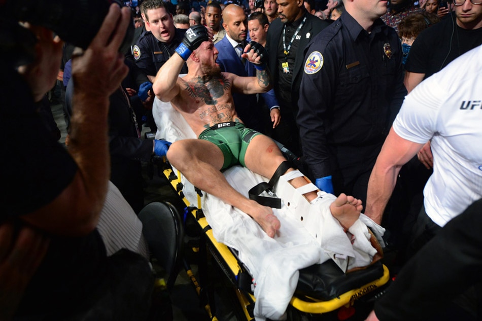 Conor McGregor stretchered off after suffering broken leg