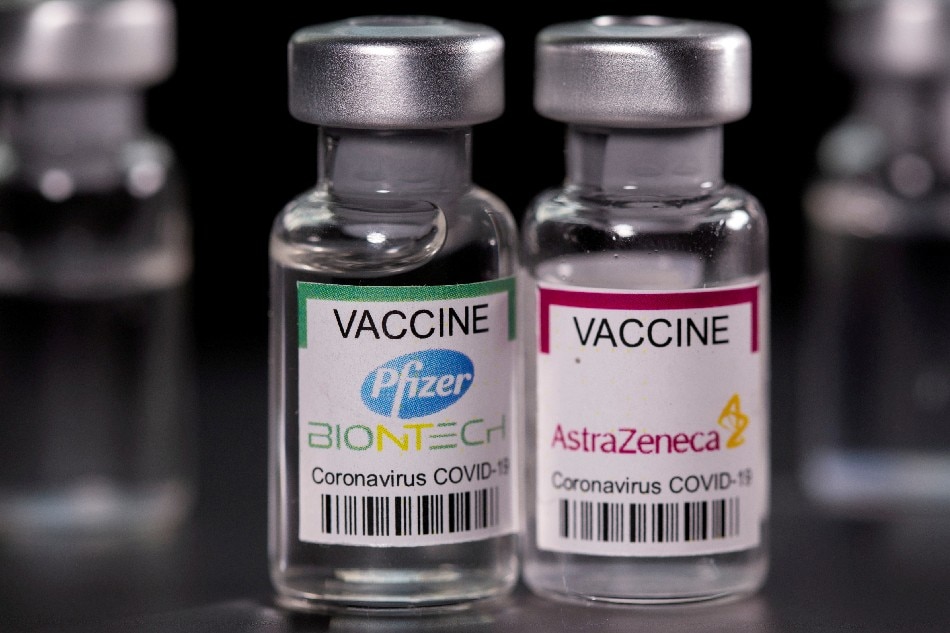 Vials with Pfizer-BioNTech and AstraZeneca coronavirus disease (COVID-19) vaccine labels are seen in this illustration picture taken March 19, 2021. Dado Ruvic, Reuters/Illustration/File Photo