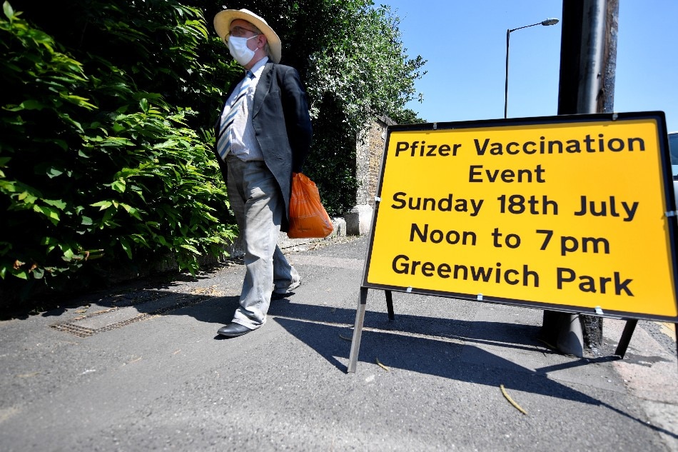 A person walks past a sign informing about a vaccination centre in Greenwich park, amid the coronavirus disease (COVID-19) outbreak, in London, Britain, July 18, 2021. Beresford Hodge, Reuters/File Photo