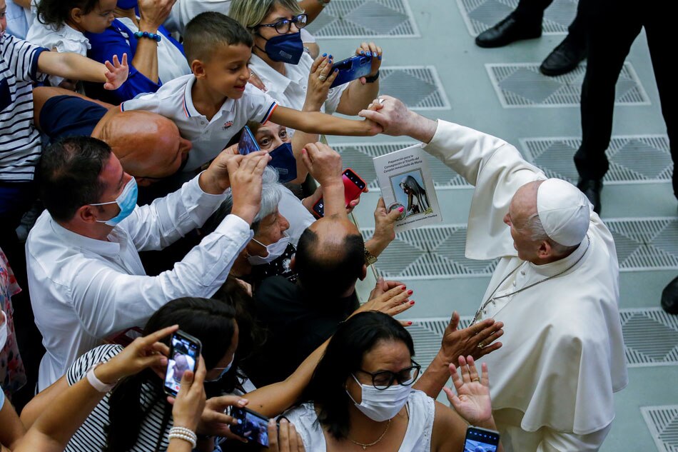 Pope Francis greets people as he leaves the Paul VI Audience Hall at the end of the weekly general audience at the Vatican, August 4, 2021. 