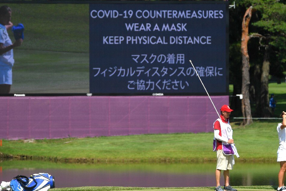 A screen displays a message indicating measures against COVID-19. August 4, 2021. Toby Melville, Reuters