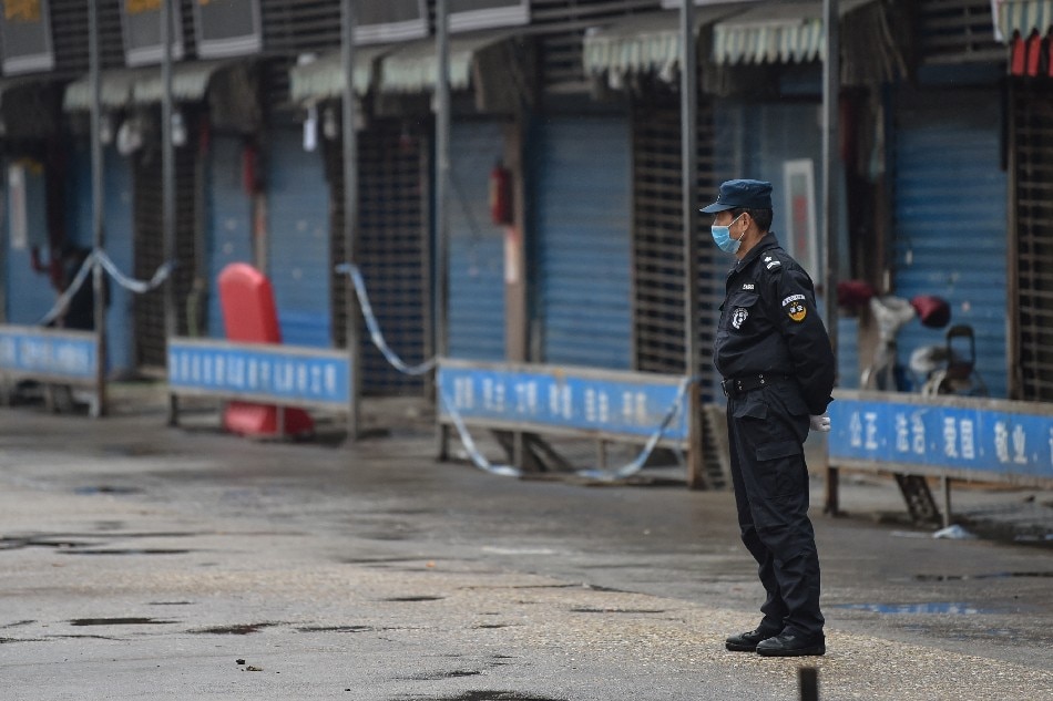 A security guard stands outside the Huanan Seafood Wholesale Market where the coronavirus was detected in Wuhan on January 24, 2020. Hector Retamal, AFP/file