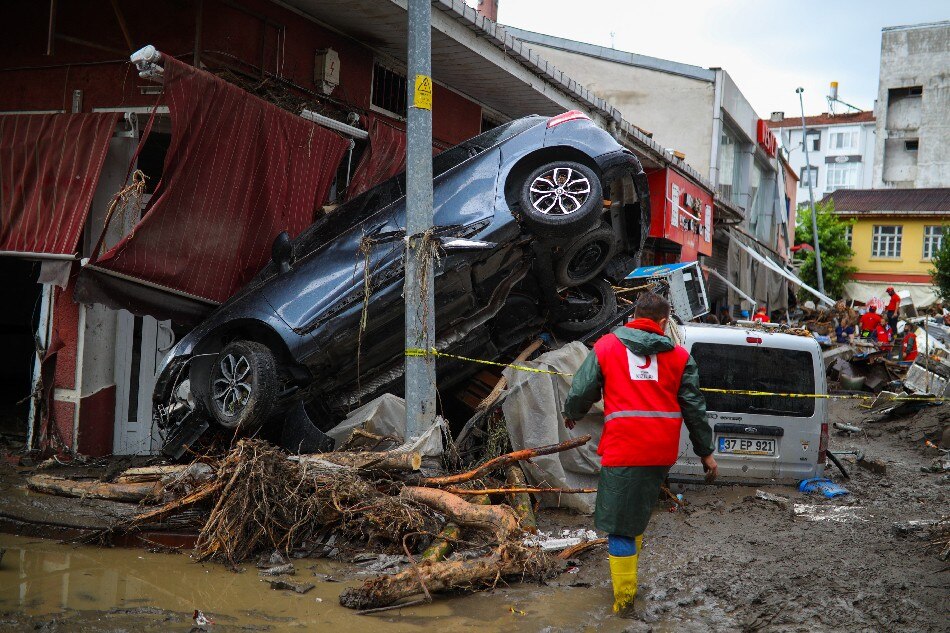 A rescue worker walks through the mud and debris after flash floods destroyed parts of the town of Bozkurt in the district of Kastamonu, in the Black Sea region of Turkey on August 14, 2021. Agence France-Presse