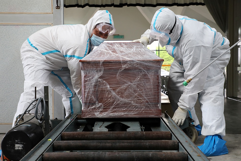 Undertakers prepare to cremate the body of a person who died from the coronavirus disease (COVID-19) in Klang, Malaysia on August 1, 2021. Lim Huey Teng, Reuters/file