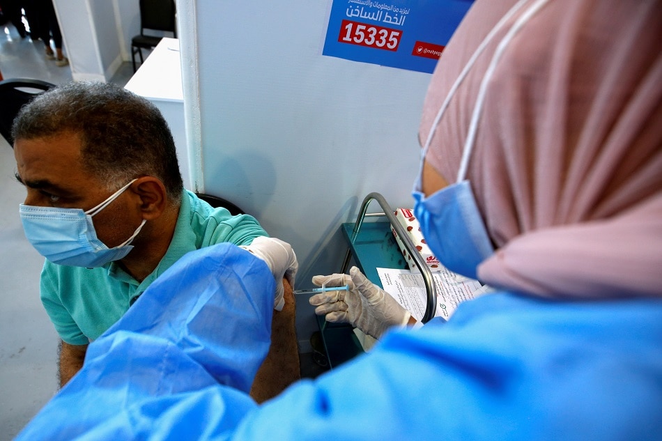 A man receives a dose of the China's Sinopharm vaccine against the coronavirus disease (COVID-19) at a mass immunization venue inside Cairo's International Exhibition Center in Cairo, Egypt