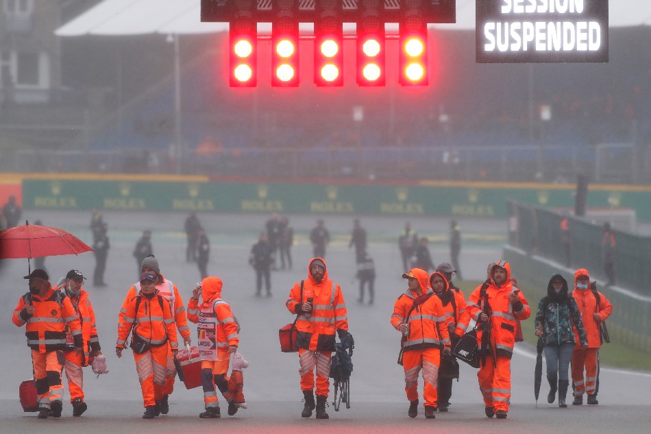 Marshals on the track after the Belgian Grand Prix is abandoned due to bad weather. Christian Hartmann, Reuters.