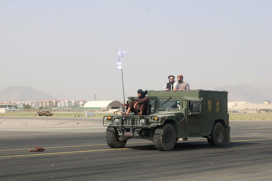 Taliban forces patrol at a runway a day after the U.S. troops withdrawal from Hamid Karzai International Airport in Kabul, Afghanistan August 31, 2021. Stringer/Reuters