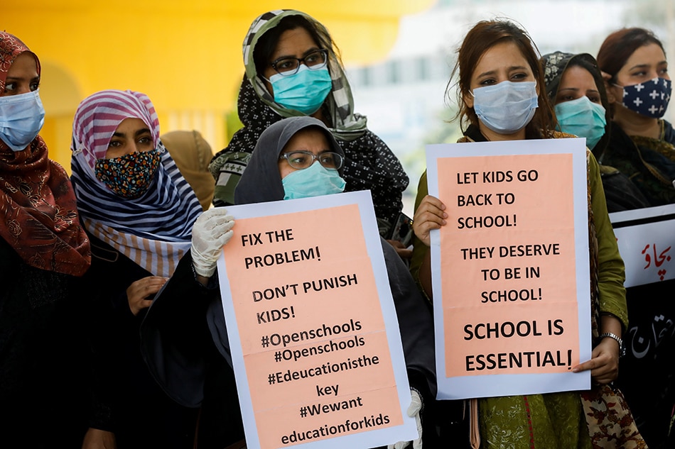 Private school teachers hold signs during a protest demanding the opening of schools, which are closed amid the coronavirus disease (COVID-19) pandemic, in Karachi, Pakistan August 23, 2021. 