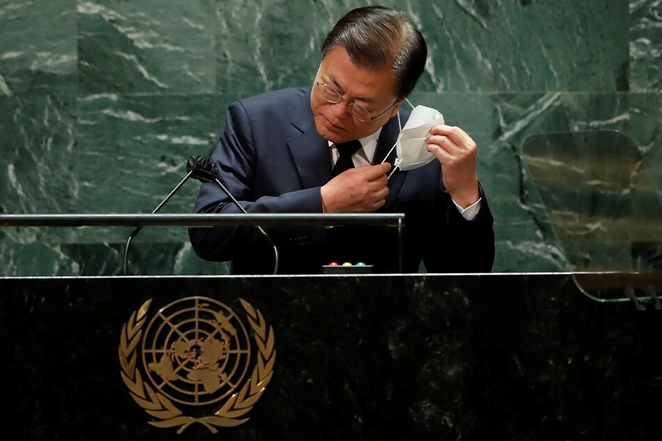 South Korea President Moon Jae-in takes off his protective face mask worn due to the COVID-19 pandemic, as he arrives to speak at the 76th Session of the UN General Assembly in New York City, U.S., September 21, 2021. Eduardo Munoz via pool, Reuters