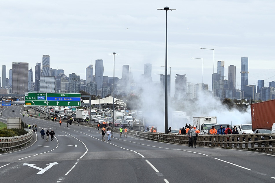 Construction workers and far right activists protest against coronavirus disease (COVID-19) restrictions on the West Gate Freeway in Melbourne, Australia, September 21, 2021. AAP Image/James Ross via Reuters