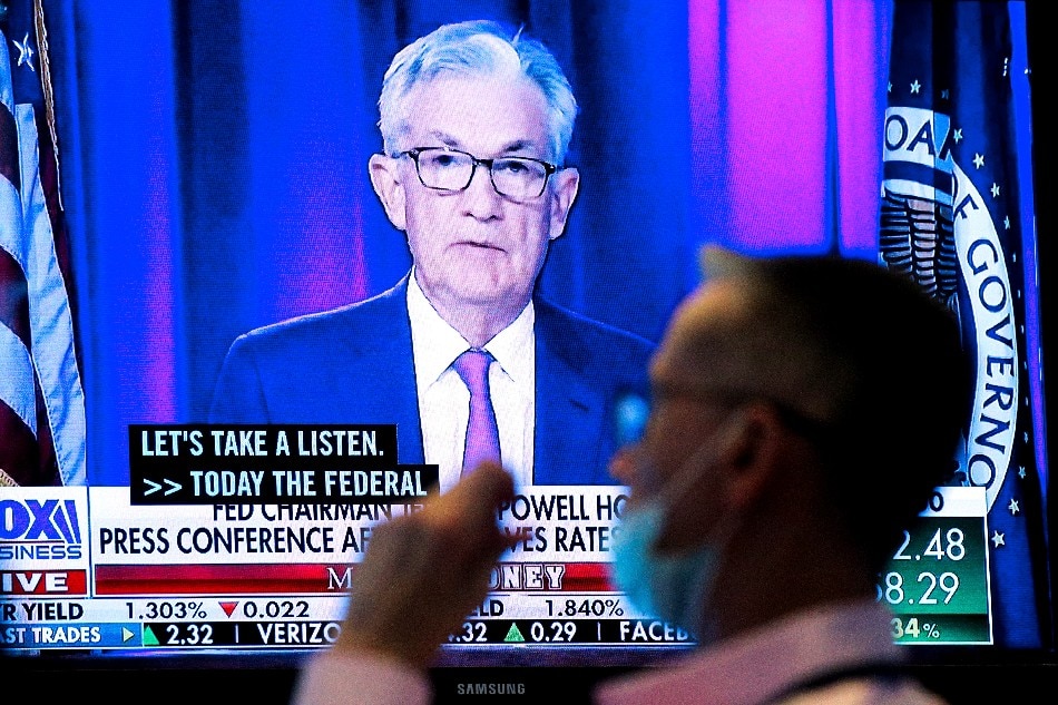 A screen displays a statement by Federal Reserve Chair Jerome Powell following the U.S. Federal Reserve's announcement as a trader works on the trading floor of the New York Stock Exchange (NYSE) in New York City, US, September 22, 2021. Brendan McDermid, Reuters