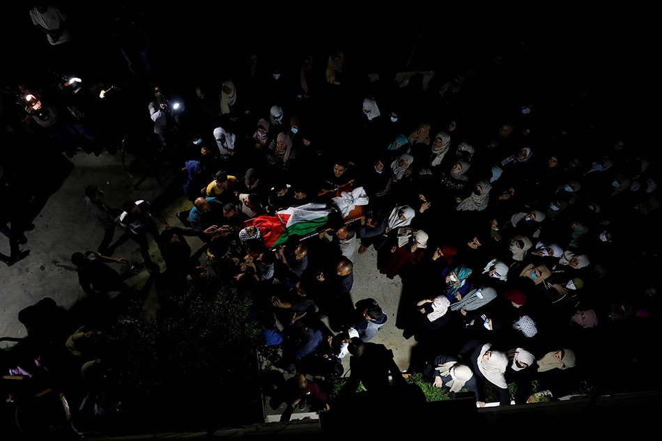 Mourners react during the funeral of Palestinian Mohammed Khabisah, who was killed by Israeli forces during clashes, in Beita in the Israeli-occupied West Bank on September 24, 2021. Mohamad Torokman, Reuters