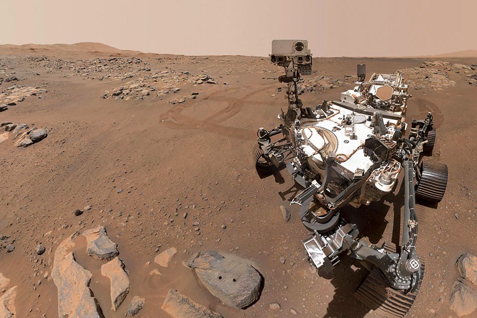 In this image released by NASA, the Perseverance Mars rover takes a selfie using its WATSON camera. The rover is positioned over a rock nicknamed 'Rochette' where two holes can be seen where the rover used its robotic arm to drill rock core samples on September 10, 2021. The Perseverance rover on Mars collected two probable samples of volcanic rock, NASA announced on September 10, 2021, stressing that the presence of salt in these rocks was an indicator of favorable conditions to possibly detect traces of ancient life.  AFP Photo/NASA/JPL-Caltech/MSSS