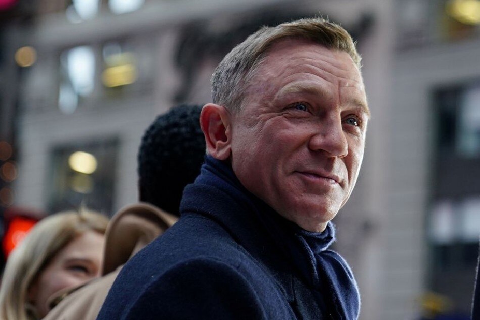 Actor Daniel Craig reacts during a promotional appearance on TV in Times Square for the new James Bond movie 