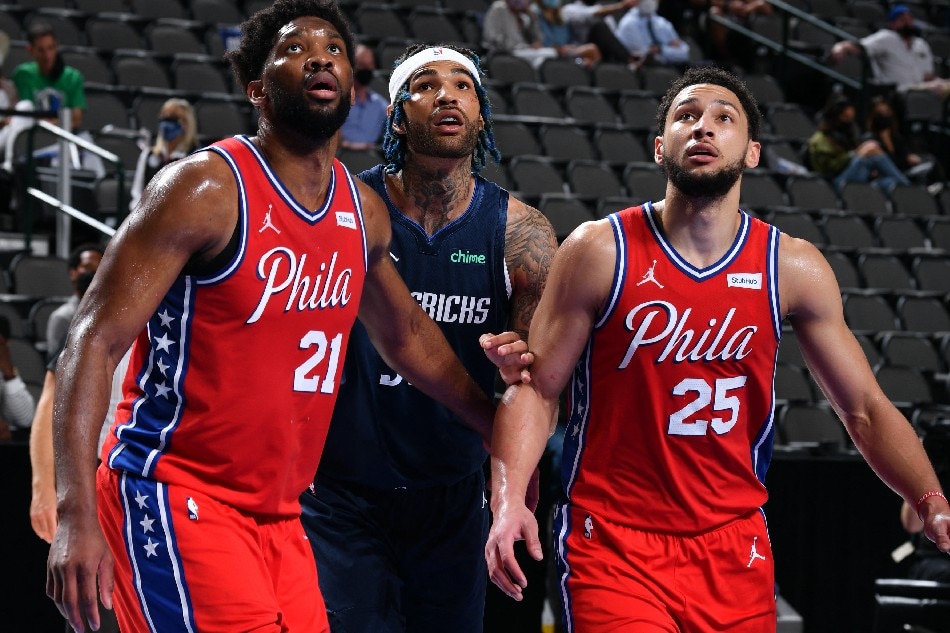 Joel Embiid (left) and Ben Simmons (right) of the 76ers look on during a game against the Mavericks on April 12, 2021 in Dallas. Glenn James, NBAE via Getty Images/AFP/file