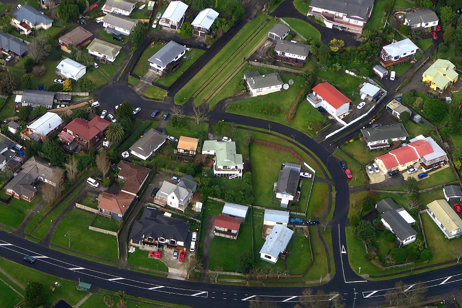 Residential houses can be seen along a road in a suburb of Auckland in New Zealand, June 24, 2017. David Gray, Reuters File Photo