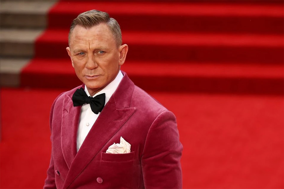 Cast member Daniel Craig poses as he arrives at the world premiere of the new James Bond film 