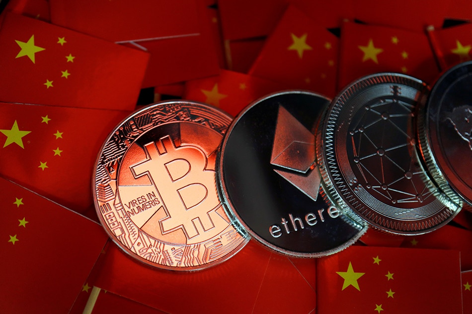 Representations of Bitcoin and other cryptocurrencies are seen amid China's flags in this illustration picture taken September 27, 2021. Florence Lo, Reuters/Illustration