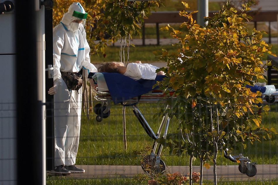 A medical specialist transports a patient outside a hospital for people infected with the coronavirus disease (COVID-19) in Moscow, Russia on October 6, 2021. Maxim Shemetov, Reuters/file