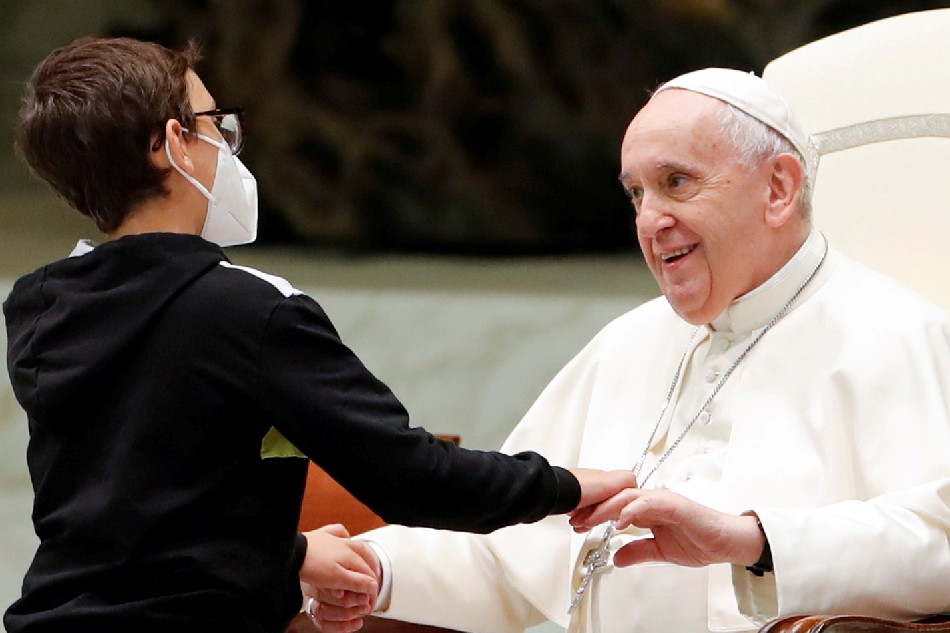 A boy greets Pope Francis during the weekly general audience at the Vatican, October 20, 2021. Remo Casilli, Reuters