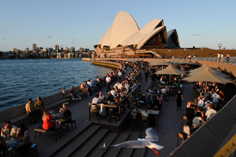 Patrons dine-in at a bar by the harbor in the wake of coronavirus disease (COVID-19) regulations easing, following an extended lockdown to curb an outbreak, in Sydney, Australia, October 22, 2021. Jaimi Joy, Reuters File Photo