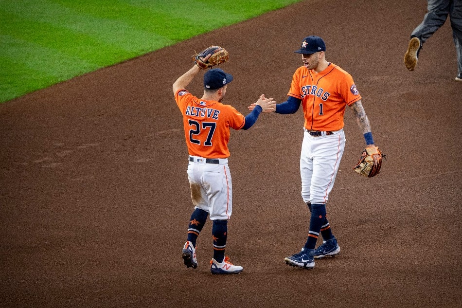 Houston Astros second baseman Jose Altuve (27) and shortstop Carlos Correa (1) celebrate the win over the Atlanta Braves in game two of the 2021 World Series at Minute Maid Park. Jerome Miron, USA TODAY Sports/Reuters.
