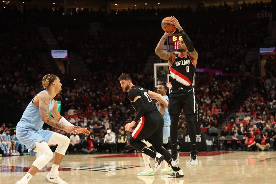 Portland Trail Blazers guard Damian Lillard (0) shoots a three-point shot over Memphis Grizzlies in the second half at Moda Center. Jaime Valdez, USA TODAY Sports/Reuters.