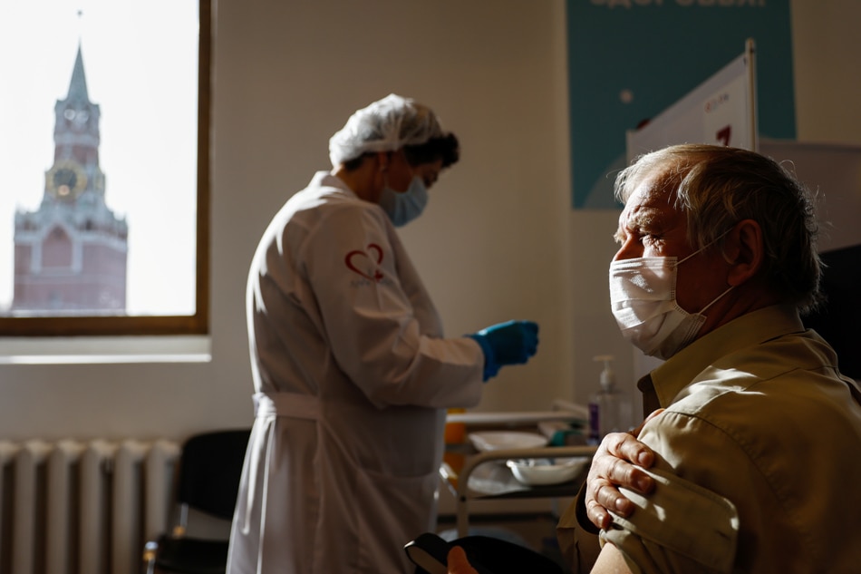 A man receives a dose of a vaccine against the coronavirus disease (COVID-19) at a vaccination centre in the State Department Store, GUM, in Moscow, Russia on October 26, 2021. Evgenia Novozhenina, Reuters 