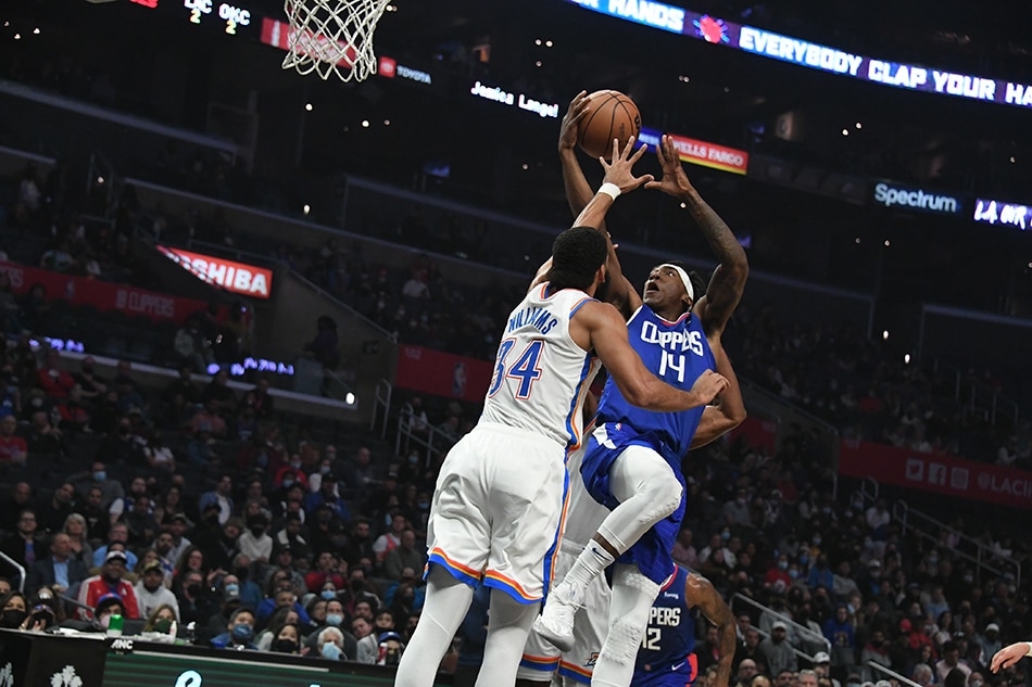 LA Clippers guard Terance Mann (14) shoots the ball defended by Oklahoma City Thunder forward Kenrich Williams (34) during the first half at Staples Center. Richard Mackson, USA TODAY Sports/Reuters