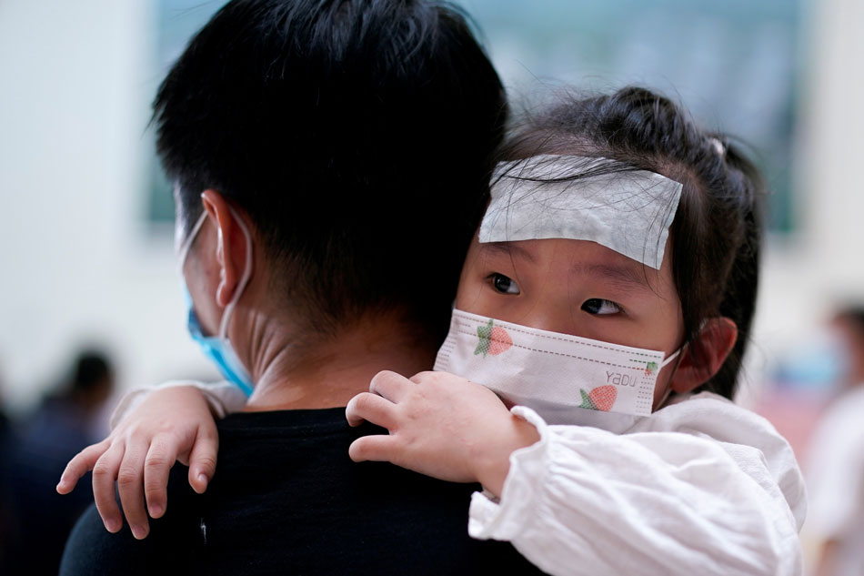 A man carries a child wearing a face mask at Tongji Hospital following the coronavirus disease (COVID-19) outbreak, in Wuhan, Hubei province, China on September 3, 2020. Aly Song, Reuters/File Photo