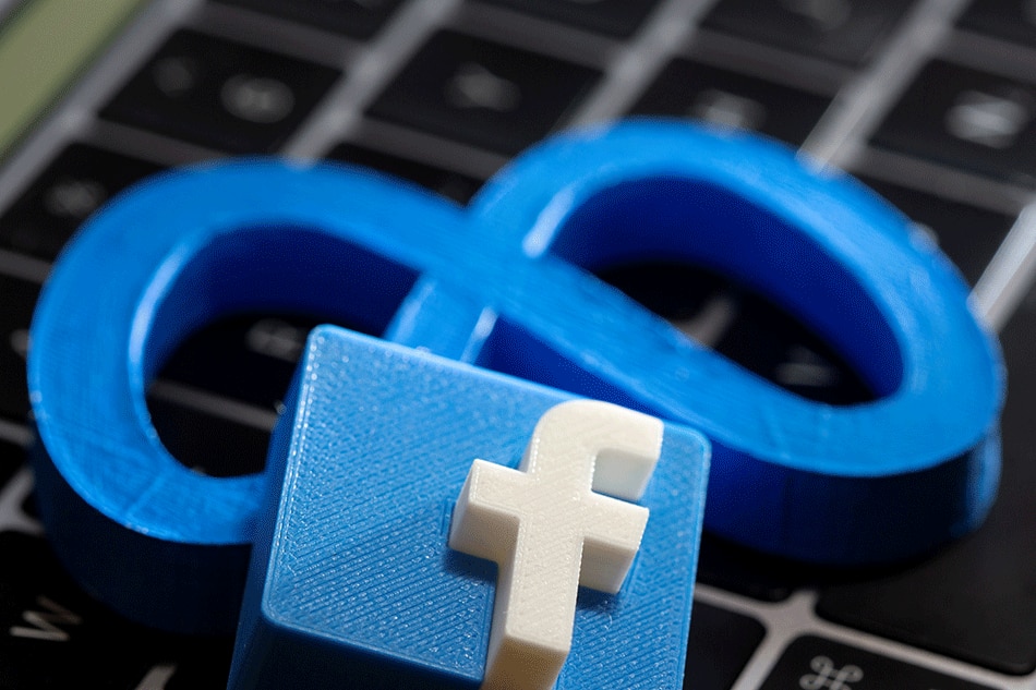 A 3D printed Facebook's new rebrand logo Meta and Facebook logo are placed on laptop keyboard in this illustration taken on November 2, 2021. Dado Ruvic, Reuters/Illustration/File Photo
