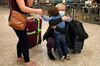 Families reunite with tears, balloons as COVID travel ban ends