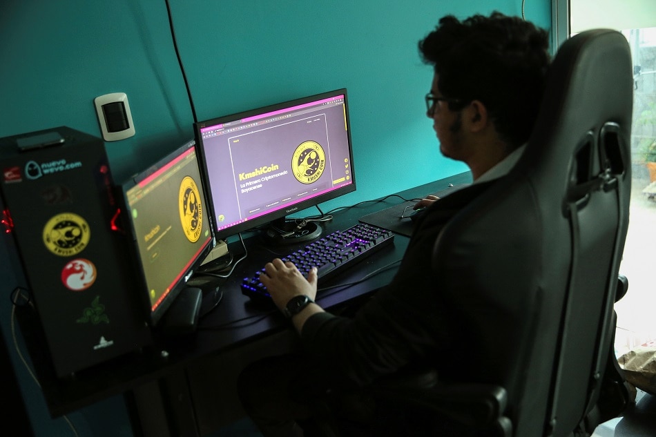 Tierra Viva's chief programmer Carmelo Campos works on the website of the cryptocurrency Kmushicoin on a computer in Tunja, Colombia, October 8, 2021. Picture taken October 8, 2021. Luisa Gonzalez, Reuters/file