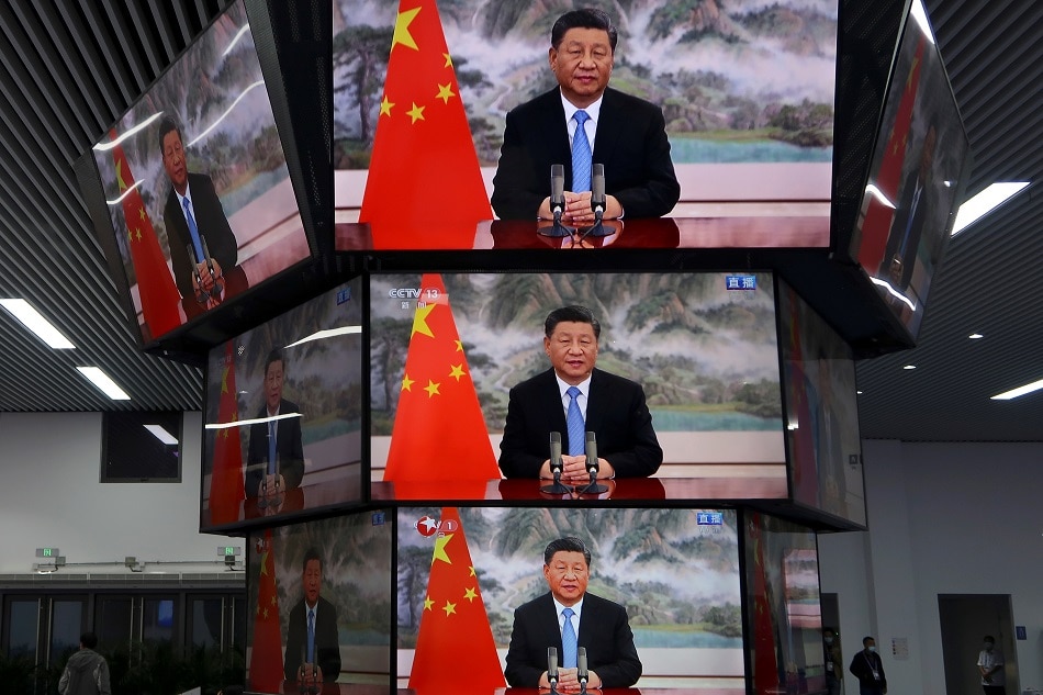 Chinese President Xi Jinping is seen on television screens at a media center, as he delivers a speech via video at the opening ceremony of the China International Import Expo in Shanghai November 4, 2021. Andrew Galbraith, Reuters