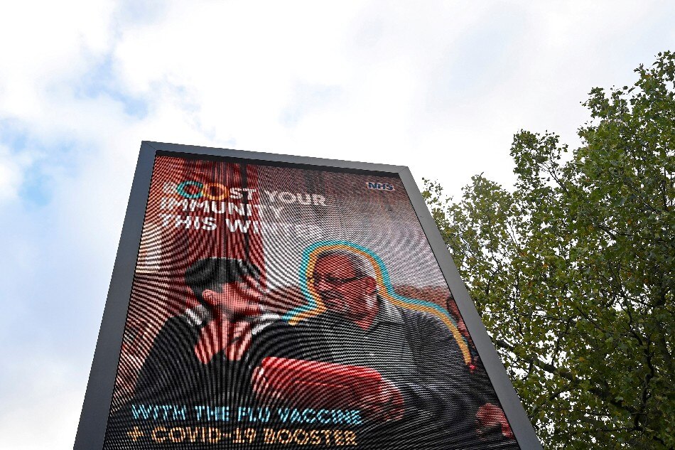 An NHS COVID-19 vaccination health campaign advertisement is displayed, amidst the spread of the coronavirus disease (COVID-19), in London, Britain, October 21, 2021. Toby Melville, Reuters/File