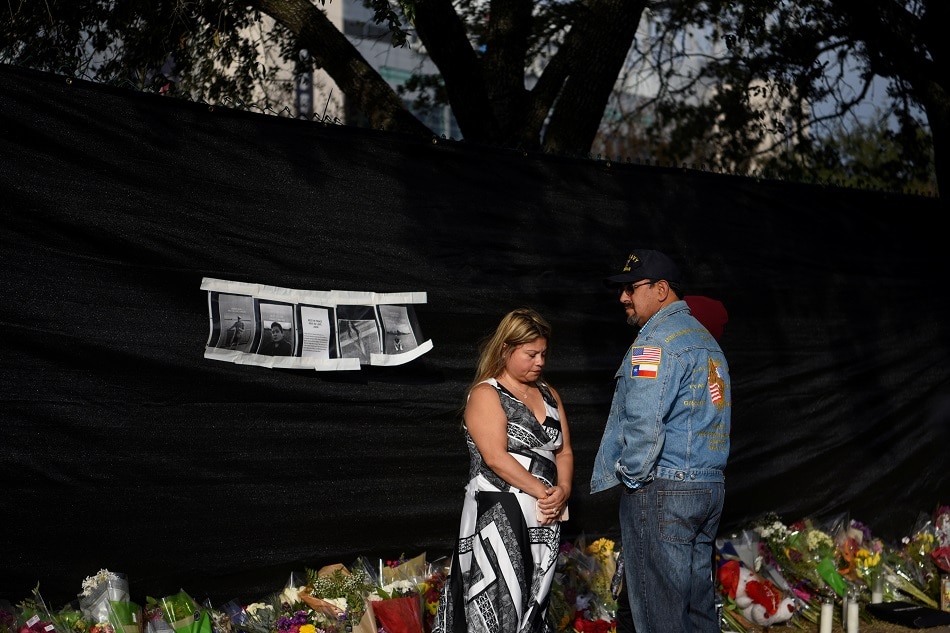 Two parents share a moment as they accompany their son, who attended the 2021 Astroworld Festival, to a makeshift memorial for the concertgoers who died in a stampede during a Travis Scott performance in Houston November 9, 2021. Callaghan O'Hare, Reuters