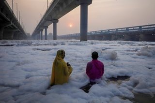 Praying amidst Yamuna’s polluted water