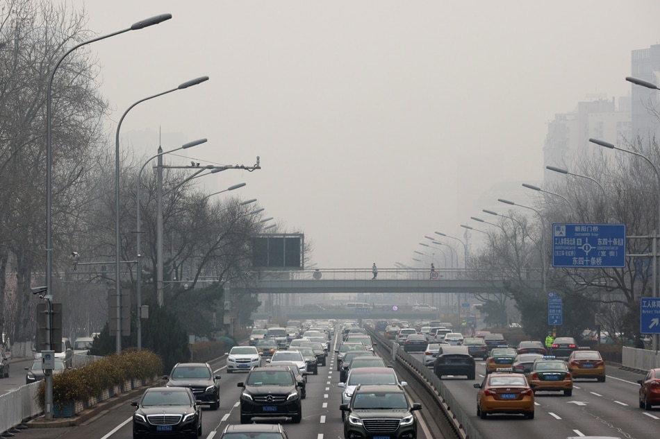 Cars are seen on the road during a polluted day in Beijing, China, on March 10, 2021. Thomas Peter, Reuters/File Photo 