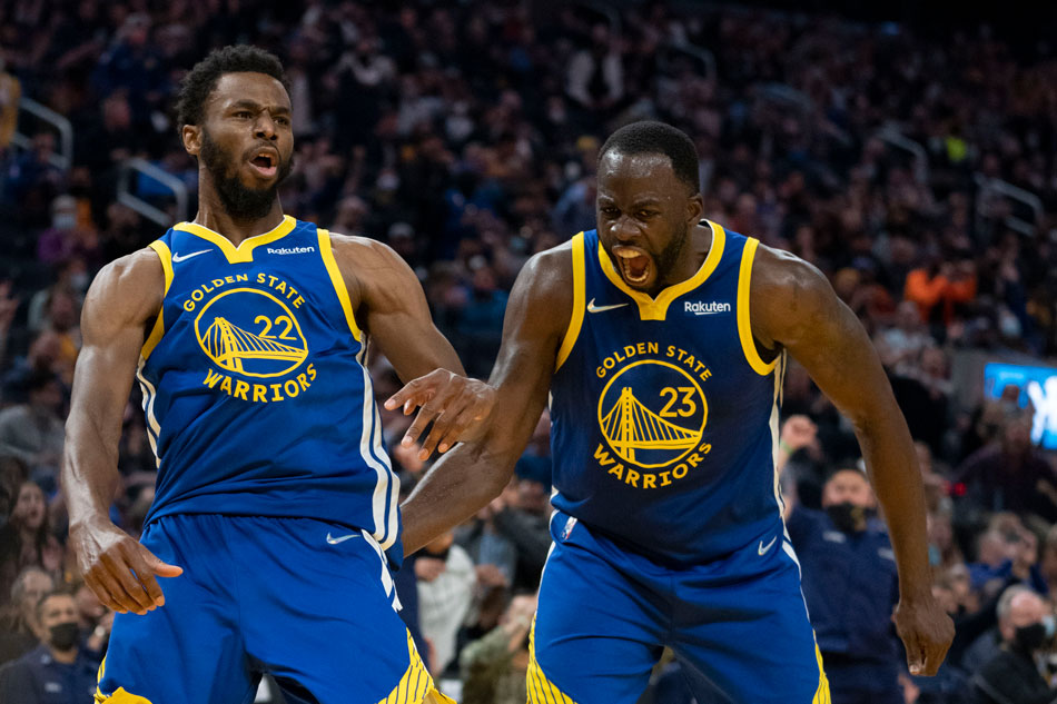 Golden State Warriors forward Andrew Wiggins (22) and forward Draymond Green (23) celebrate against the Minnesota Timberwolves during the second quarter at Chase Center. Kyle Terada, USA TODAY Sports/Reuters.