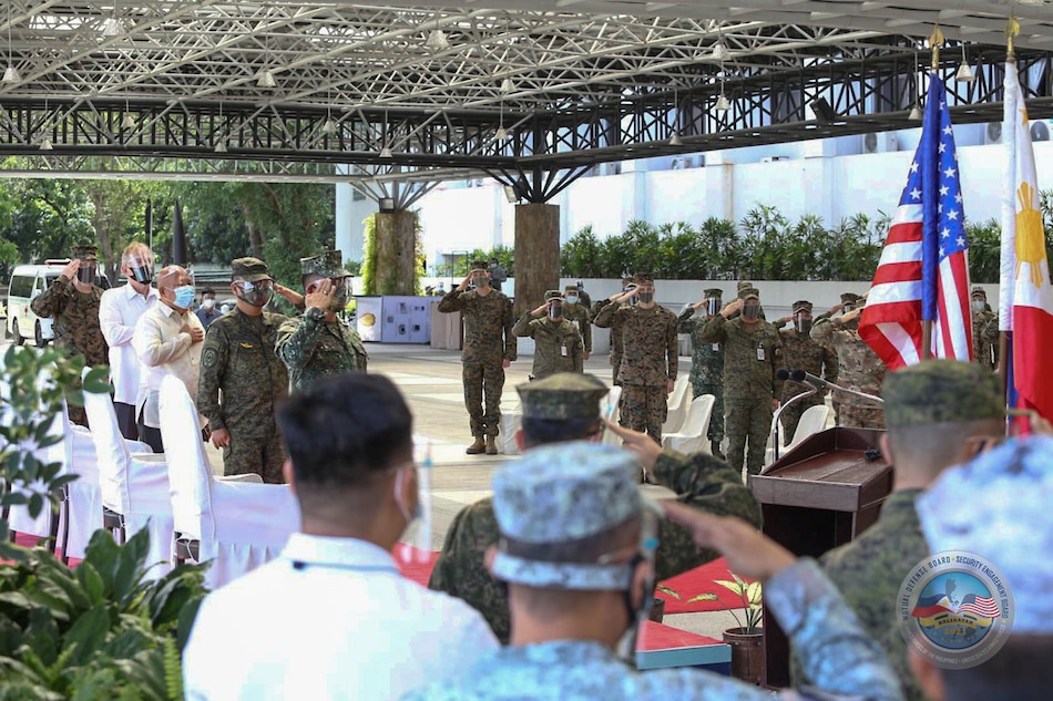 Members of the Armed Forces of the Philippines (AFP) and United States Military attend the opening of the 36th Balikatan Exercise (BK36-21) wearing masks and maintaining social distancing amid the coronavirus disease (COVID-19) pandemic, at Camp Aguinaldo, Quezon City on April 12, 2021. Armed Forces of the Philippines handout via Reuters/File
