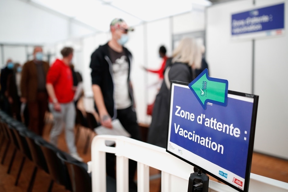 People wait before receiving a dose of the Comirnaty Pfizer BioNTech COVID-19 vaccine at a vaccination center in Saint-Nazaire, France, November 9, 2021. Stephane Mahe, Reuters