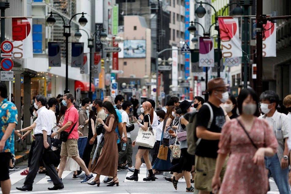 People walk at a crossing in Shibuya shopping area, amid the COVID-19 pandemic, in Tokyo, Japan, Aug. 7, 2021. Androniki Christodoulou, Reuters/File