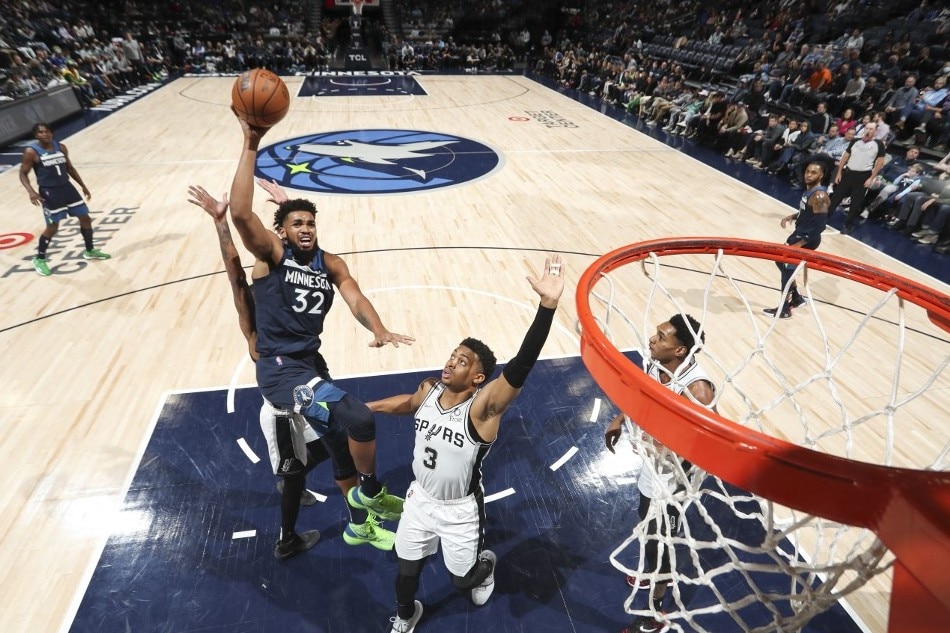 Karl-Anthony Towns (32) of the Minnesota Timberwolves shoots the ball against the San Antonio Spurs at Target Center in Minneapolis, Minnesota. Jordan Johnson, NBAE via Getty Images/AFP