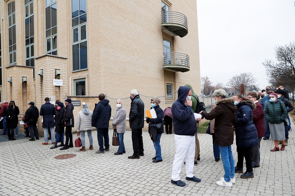 People stand in a queue for vaccination in front of a hospital as the spread of the coronavirus disease continues in Budapest, Hungary, November 22, 2021. Bernadett Szabo, Reuters